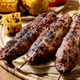 Grilled beef kebab on sticks on flat bread with grilled vegetables